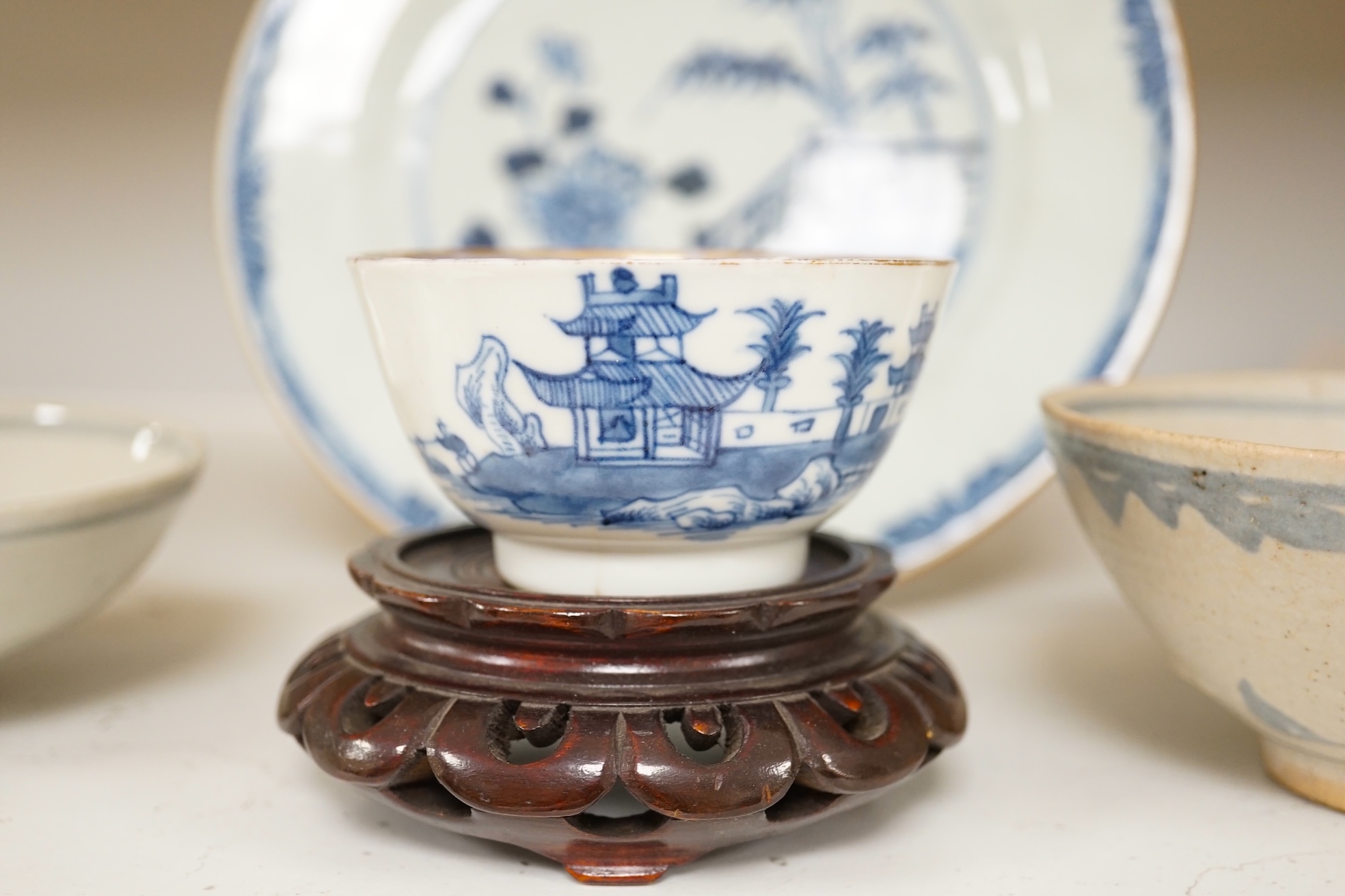 A Chinese blue and white plate, a tea bowl, two pottery bowls and a wooden stand (5). Condition - fair to good.